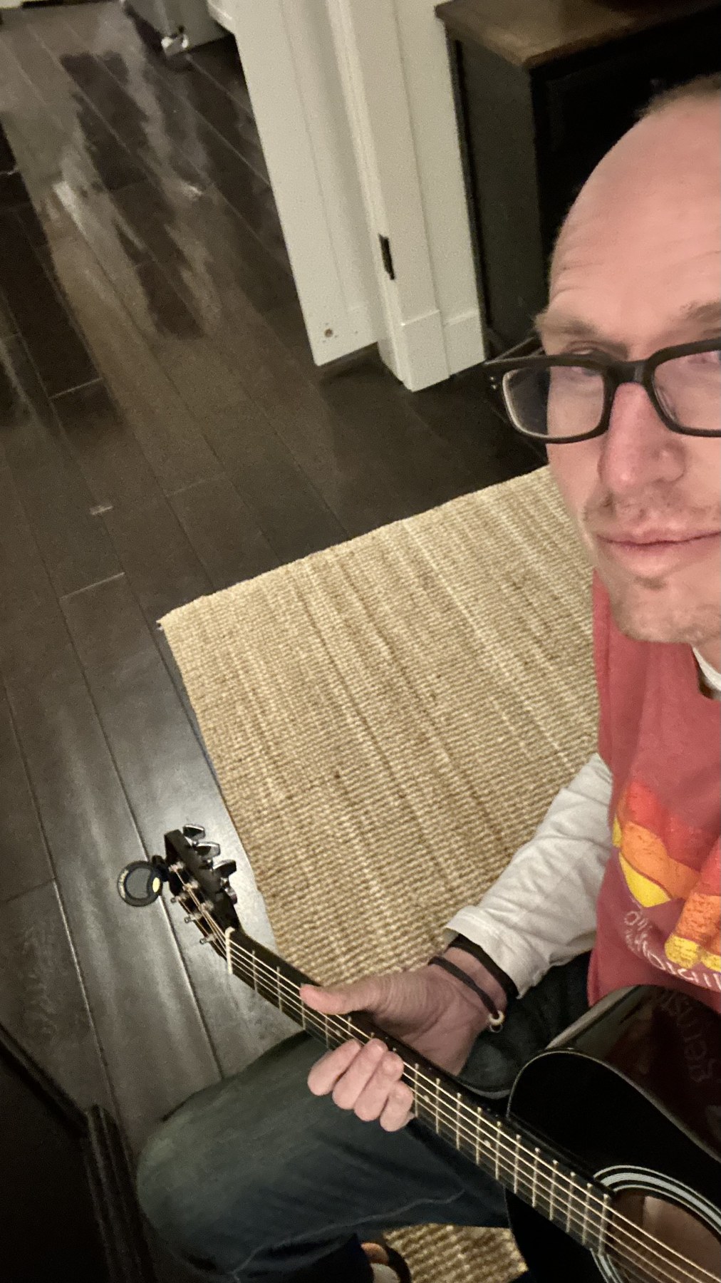 Cory at home with his acoustic guitar